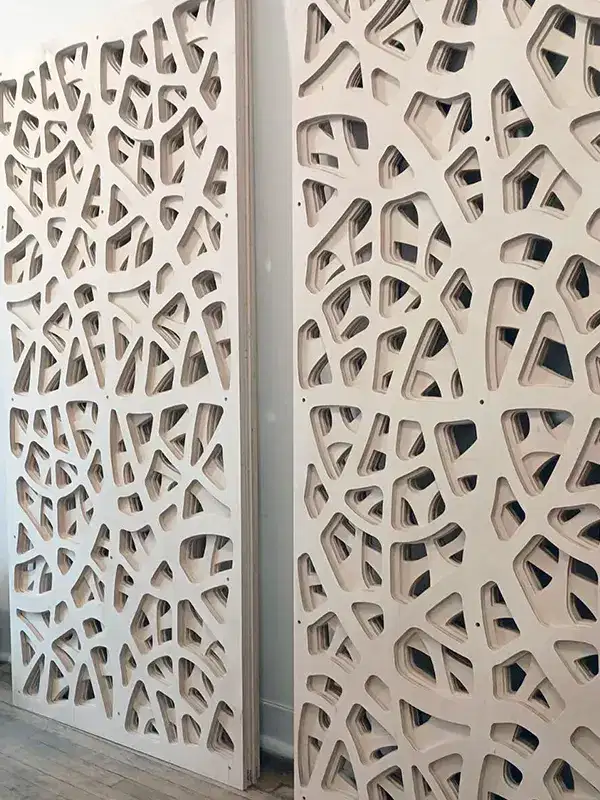 Large birch plywood architectural panel with an intricate CNC-cut geometric pattern