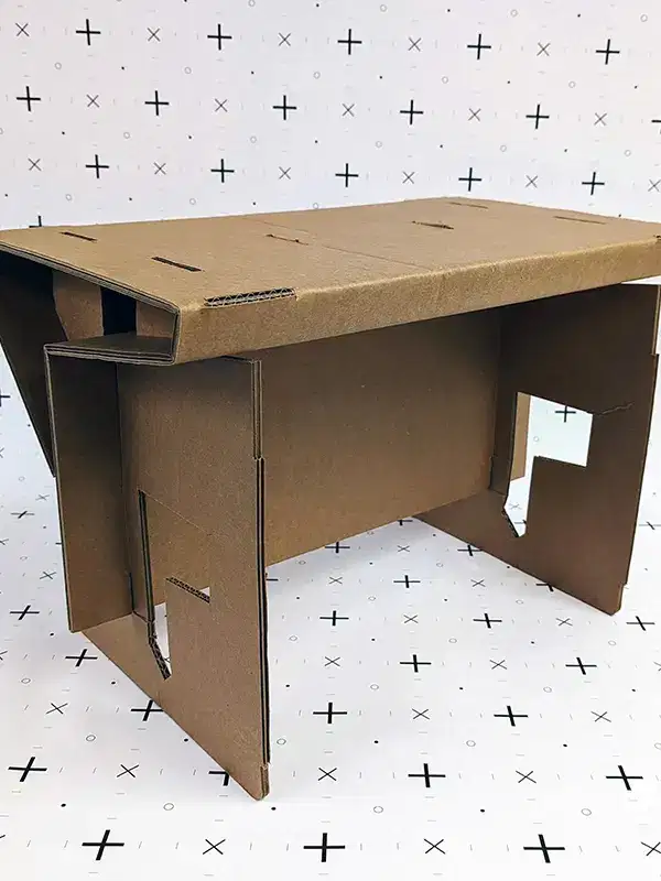 Three interlocking cardboard panels forming a small, lightweight table